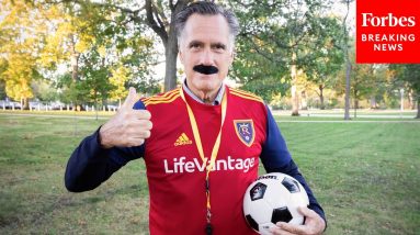 Romney Dresses Up As Ted Lasso And Gives ‘Biscuits To The Boss’ Sinema